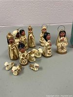 Hand-painted Latin American miniature nativity figurines and animal characters with earth tones and gold details