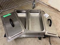 Full view of Bravetti two entrée electric buffet server with lids opened showing stainless steel pans inside.