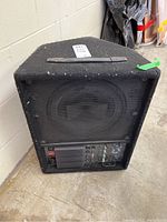 Full view of amplifier unit showing front speaker grille and bottom control panel.