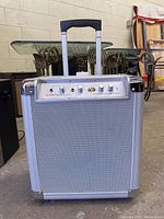 Front angle view of Ion Block Rocker portable speaker system showing overall condition and retractable handle.