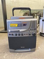 Front view of Venturer karaoke machine with all controls and CD graphics display visible