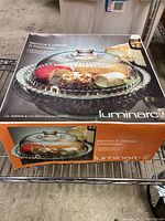 Photo of Luminarc 2-piece cheese server box showing glass platter and dome with cheese items under dome.