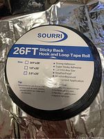 Top view photo of the tape roll label showing brand name Sourri, size options with 2" x 26' selected, and some usage instructions and features.