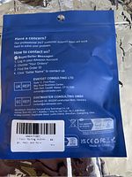 Back of sealed blue packaging with customer support contact info and manufacturer details