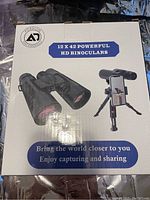 Front of box showing binaculars and phone holder, '12x42 Powerful HD Binoculars'