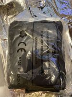 Photo of the boxed inflatable punching bag with black packaging showing recycling and safety warnings.
