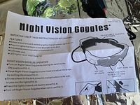 Instruction sheet for night vision goggles detailing features and operation with illustrations.