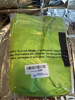 Photo showing green grass color packing cubes still sealed in plastic packaging with product label visible.