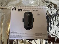 Front view of the wireless car charger box showing product image, brand, power output (15W), and basic specifications including input voltage, size, and material.