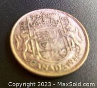 Reverse side of the 1946 Canadian 50 cent coin displaying the Canadian Coat of Arms and the inscription 'CANADA 1946'.