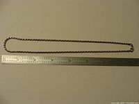 Full length of the sterling silver rope chain necklace alongside a ruler showing approximately 15 inches length
