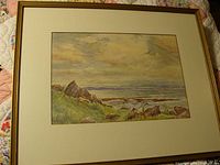 Full view of the framed vintage coastal landscape print by J Calder Smith showing natural scenery with rocks, water, and sky.