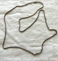 Full length view of vintage twisted sterling silver chain necklace laid flat showing the entire item.