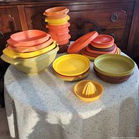 Top view showing all Tupperware components arranged on a table with direct light highlighting colors and shapes