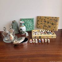 Full view of the 10 piece lot including thimbles, perfume bottles, vases, boxes and plaque