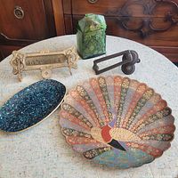 Overview of all five items on table showing brass and glass pieces, various shapes and colors
