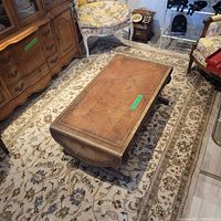 Full view of the white wool area rug under furniture, showing the overall pattern and condition.