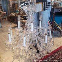 Front view of 24" crystal chandelier showing ten candelabra sockets and hanging glass prisms