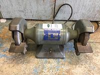 Full view of Baldor double grinder showing the two grinding wheels and metal base.