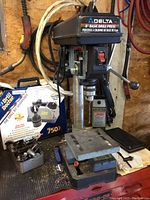 Delta 8" Basic Drill Press on workbench with Drill Doctor 750X box and black bit sharpener