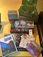 Overview showing storage boxes, plastic tray with gemstones and books