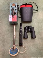 Full lot showing metal detector with coil, binoculars, and telescope