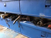 Blue storage unit with various power tools placed along the edge.