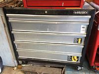 Black and silver Husky roller tool chest with drawers on caster wheels