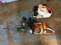 Overall view of Stihl engine housing, green adapter and driver bit.