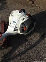 Gas-powered Stihl FS 56 RC string trimmer, showing control handle, starter cord, and ventilation area.