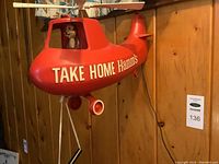 Front view of red plastic helicopter with “TAKE HOME Hamm’s” lettering