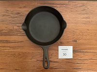 Top view of the cast iron pan showing the cooking surface and handle.