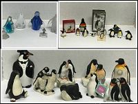 Various penguin figurines in glass, ceramic and fabric, displayed on white shelves