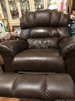 Front view of a brown leather full size recliner chair showing padded cushions on backrest, seat, and armrests.