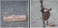 Photo showing a vintage wooden hand plane and an antique hand drill with a crank handle and gear mechanism on an outdoor surface.
