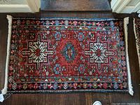 Full view of the oriental rug mat showing overall pattern, colors, and fringes.
