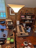 Full view of the brass floor lamp in a room featuring the base and shade, showing the height and setting.
