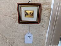 Framed Hungarian street scene print showing the full frame and wall background.