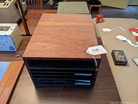 Full top and side view of the teak desktop organizer showing wood grain and all shelves inserted.