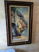 Framed oil painting of Mediterranean coastal scene by Giovanni Camprio hanging on wall showing full artwork and frame.