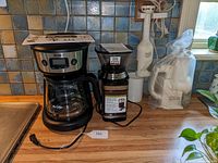 View of all four kitchen appliances on countertop near a window.