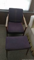 Front view showing purple upholstered chair and matching ottoman