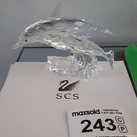 Clear Swarovski crystal dolphin figurine from left side