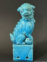 Front view of the turquoise glazed Chinese lion statue showing facial details and front posture.