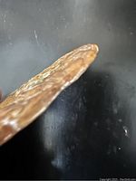 Side view showing thin profile and coloration of antique jade pad.