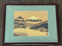 Full view of the framed Mount Fuji artwork showing the frame and surrounding green mat.