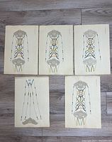 Front view of five Japanese antique woodblock prints showing traditional motifs and colors