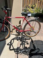 Three-quarter view of red Raleigh Ozark bicycle with adjustable trunk rack in foreground