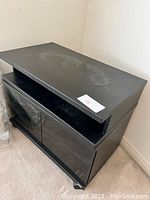 Showing the swivel top surface with some marks and signs of use, flat in black finish.