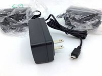 Three black SafetyPro 5V 2A power supply adapters in clear plastic bags, showing the attached cables and foldable two-prong plugs.